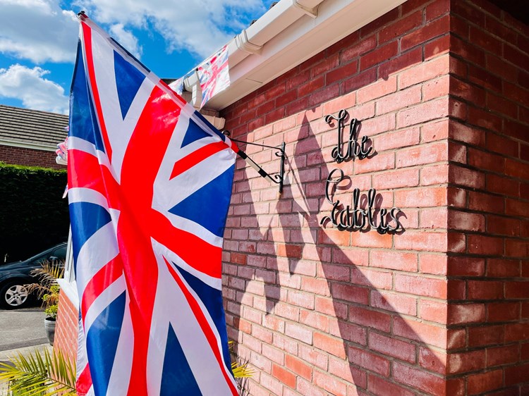 Exterior view of The Gables with a British flag.