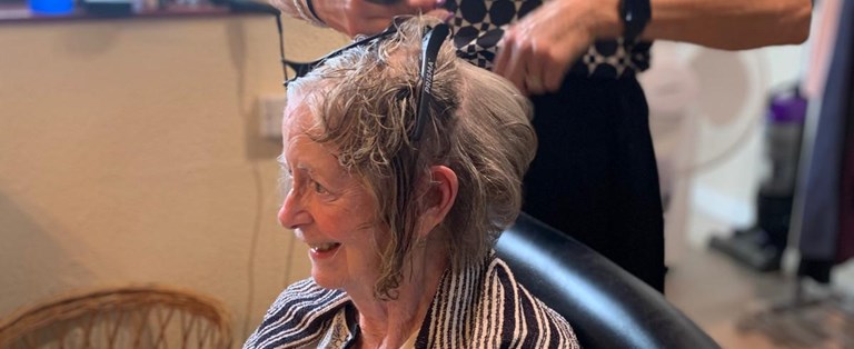 Senior woman getting a hair treatment at a salon