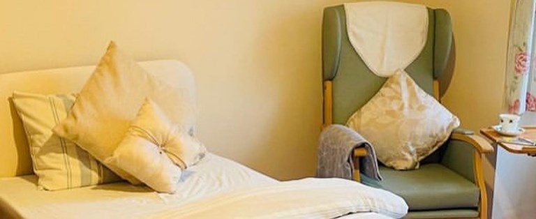 Cozy resident room with bed and chair