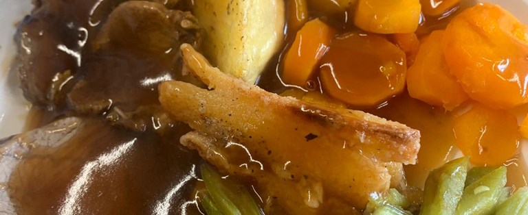 Plate of prepared meal with vegetables.