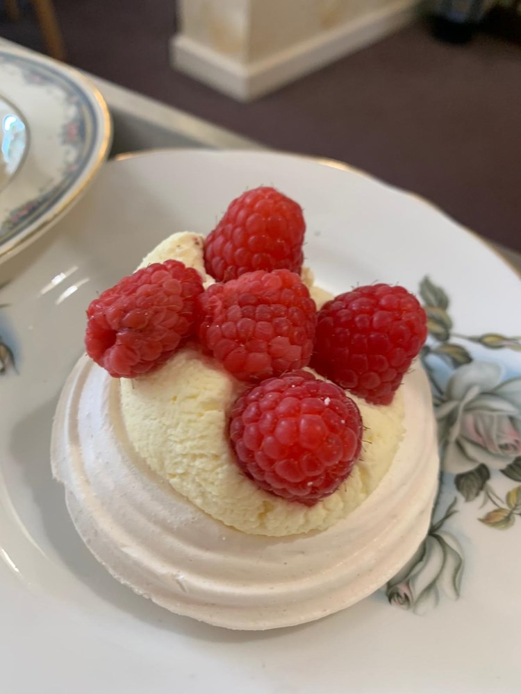 Dessert with raspberries served on a floral plate