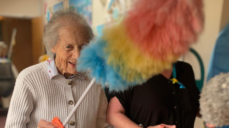 Resident engaging in a fun cleaning activity.