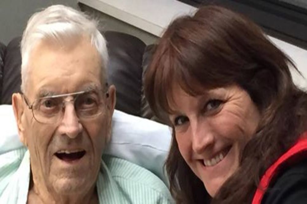 Smiling staff member with an elderly resident.