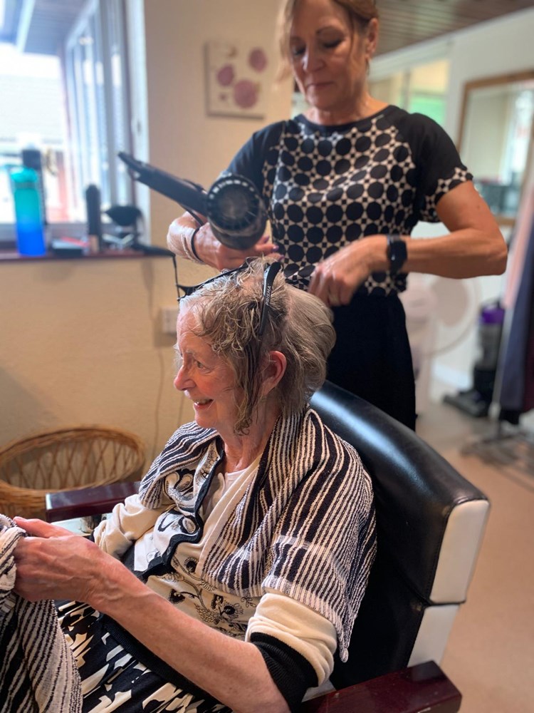Resident getting hair styled at the facility's salon