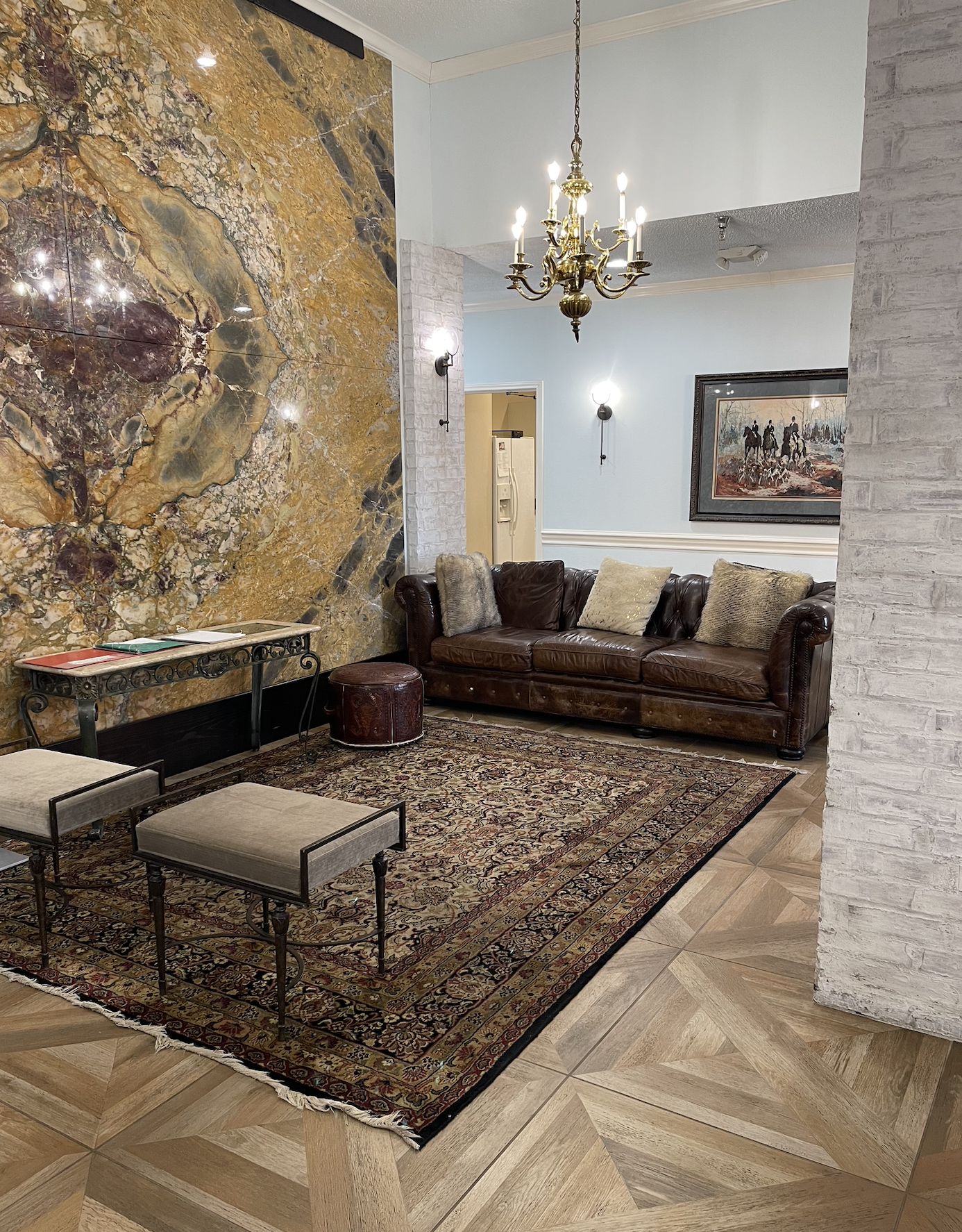 Cozy common area with leather couch and decorative rug