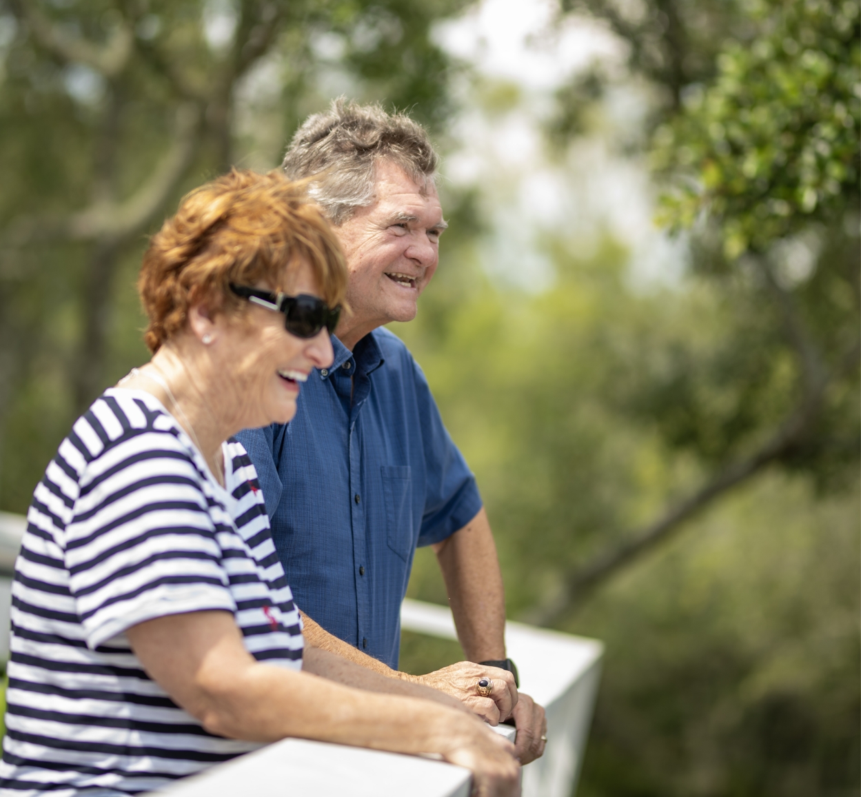 Two smiling residents outdoors enjoying the day.