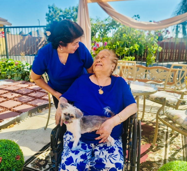 Staff interacting with a resident outdoors.