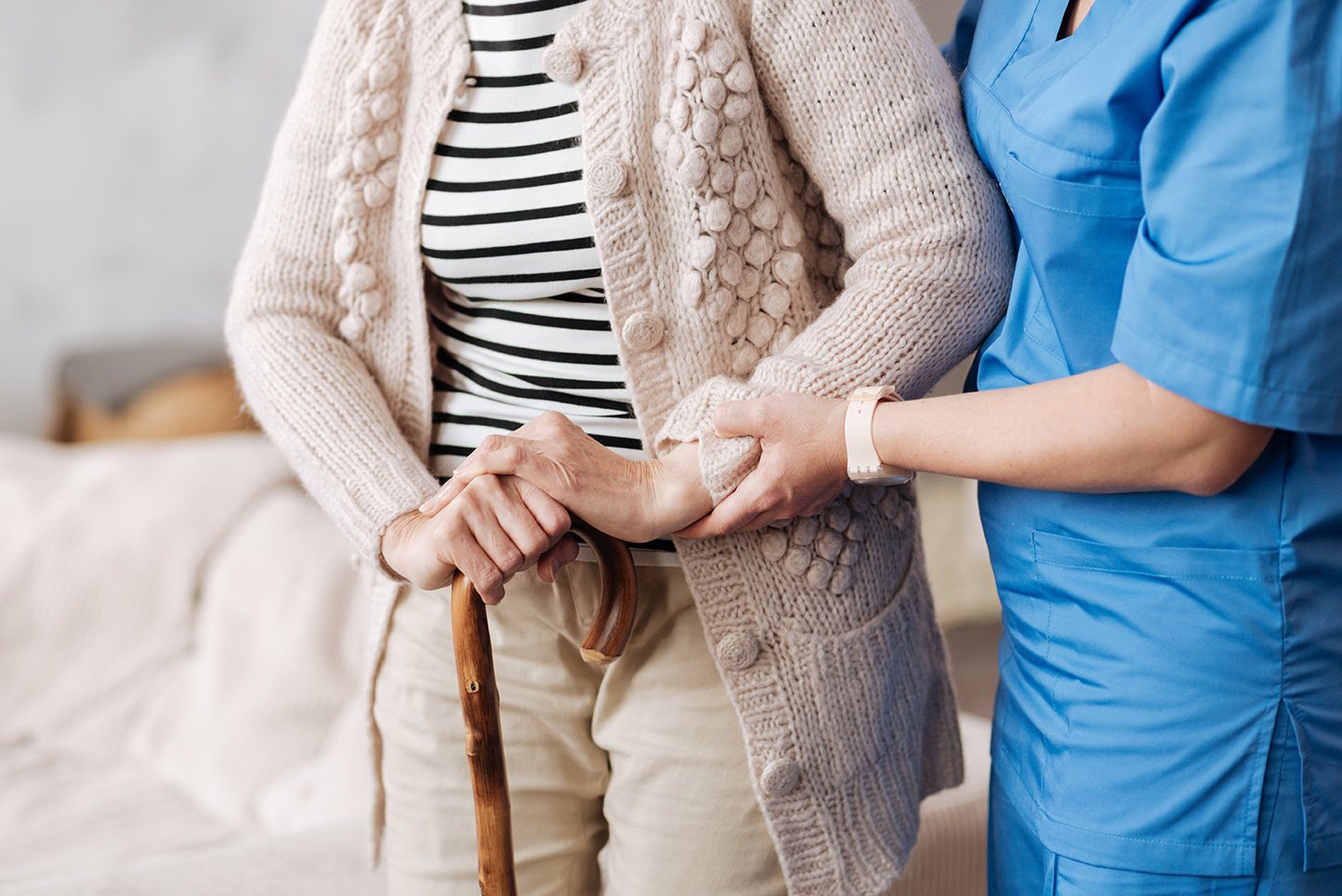 Caregiver assisting a resident in a cozy setting