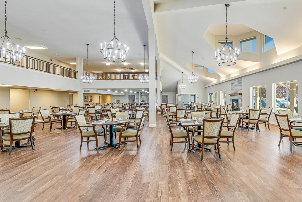 Bright dining room with tables and chairs arranged