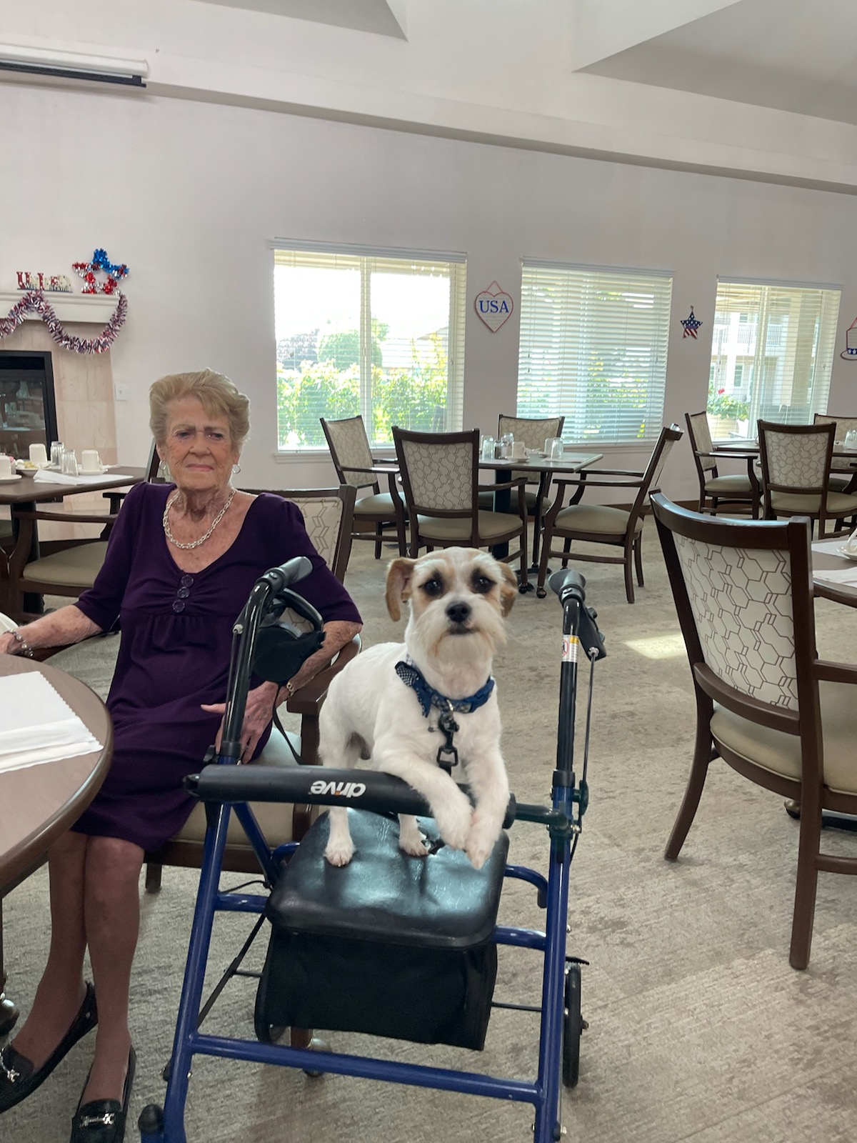 Resident with a dog in the dining area