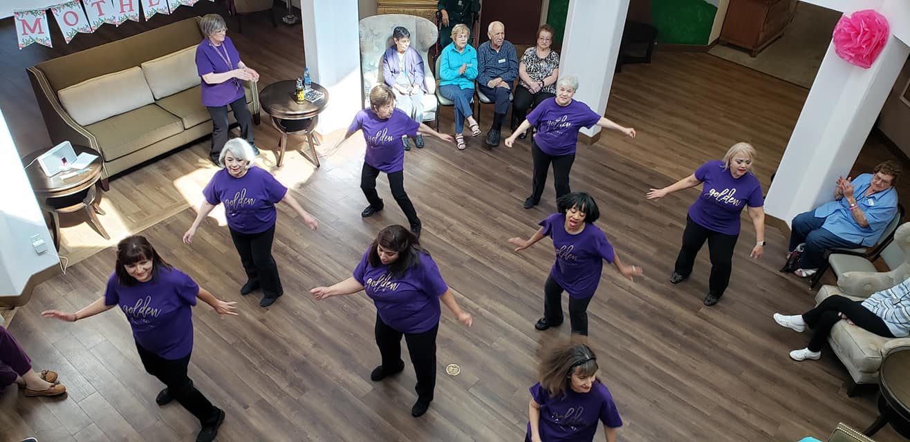Residents participating in a dance activity in a common area