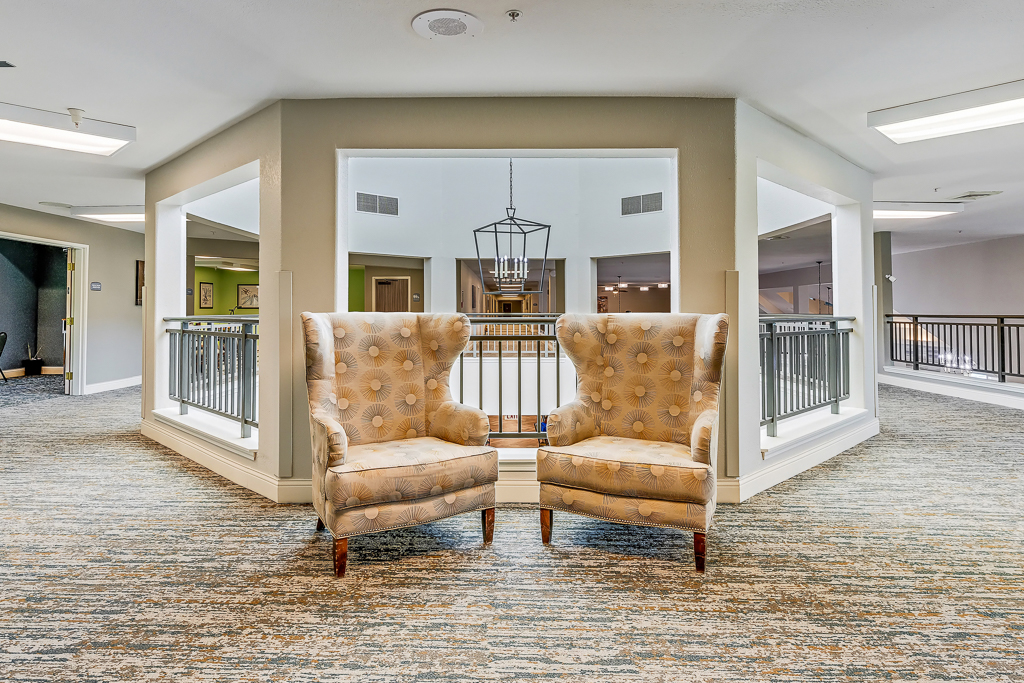 Common area with two armchairs and balcony view