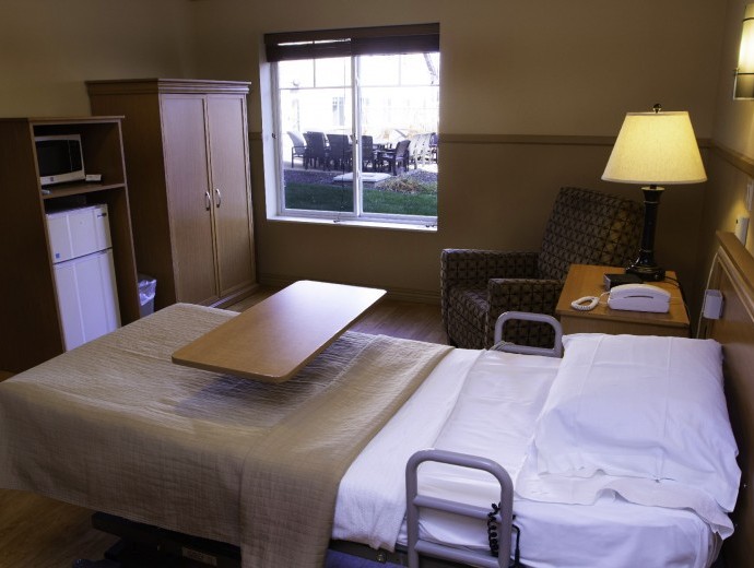 Interior view of a resident room with a bed and seating area