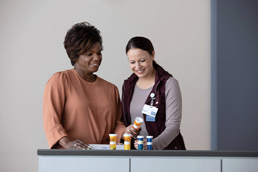 Healthcare staff assisting a resident with medications