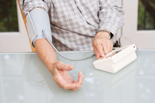 A resident's arm using a blood pressure monitor