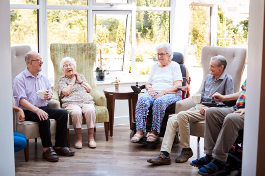 Residents enjoying a lively conversation in a common area
