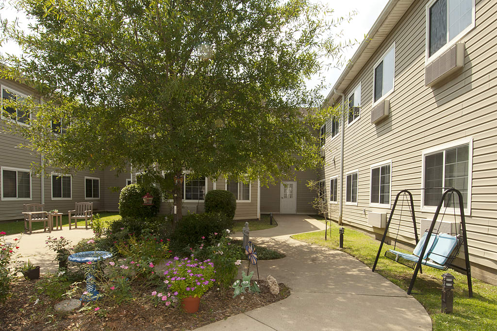 Outdoor courtyard with seating and flower beds