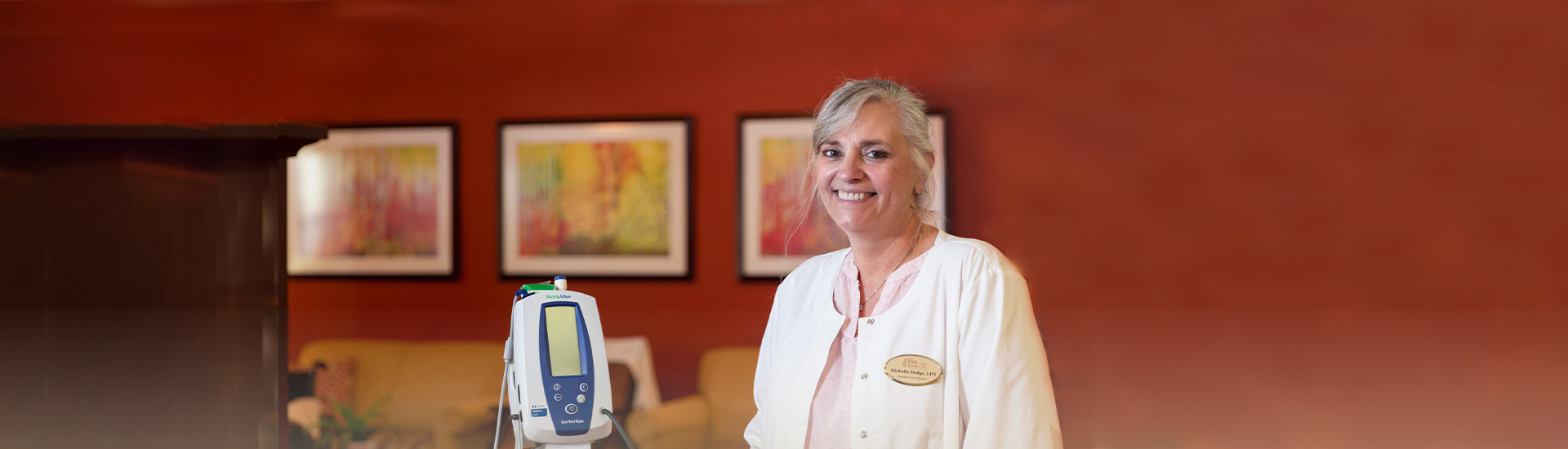 A staff member smiling in a bright facility setting