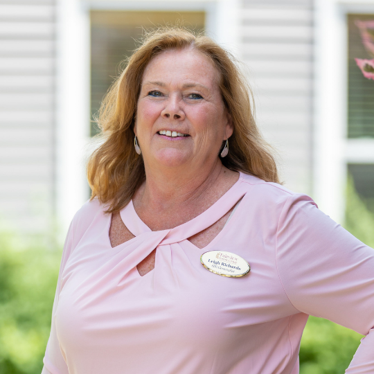 Staff member smiling outside the facility