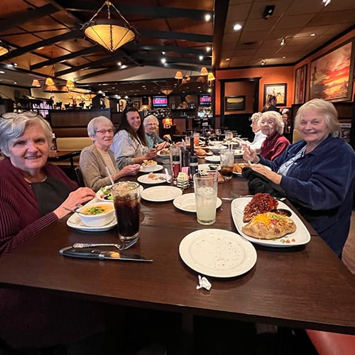 Residents enjoying a meal together in the dining room