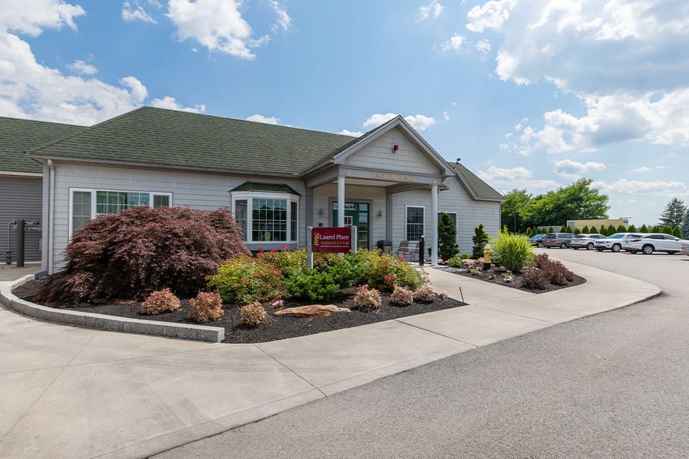 Exterior view of a senior living facility with landscaped gardens