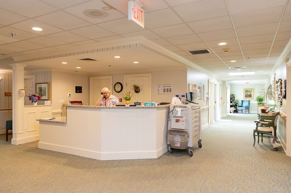 Reception area in a senior living facility with staff.