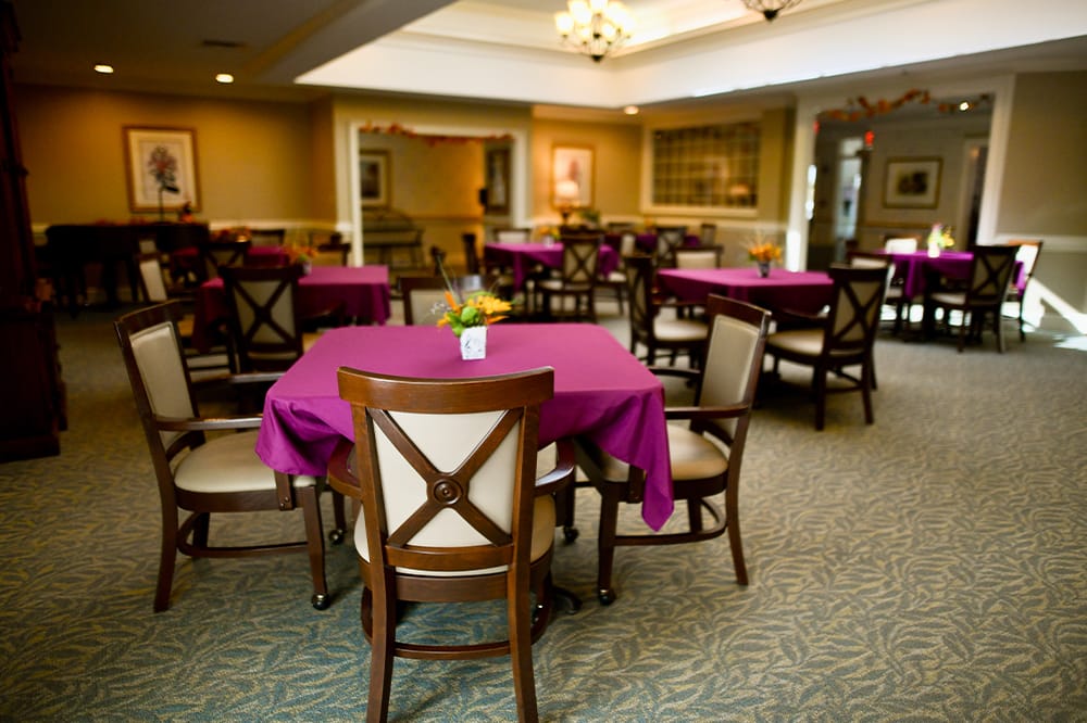 Dining area with purple tablecloths and chairs
