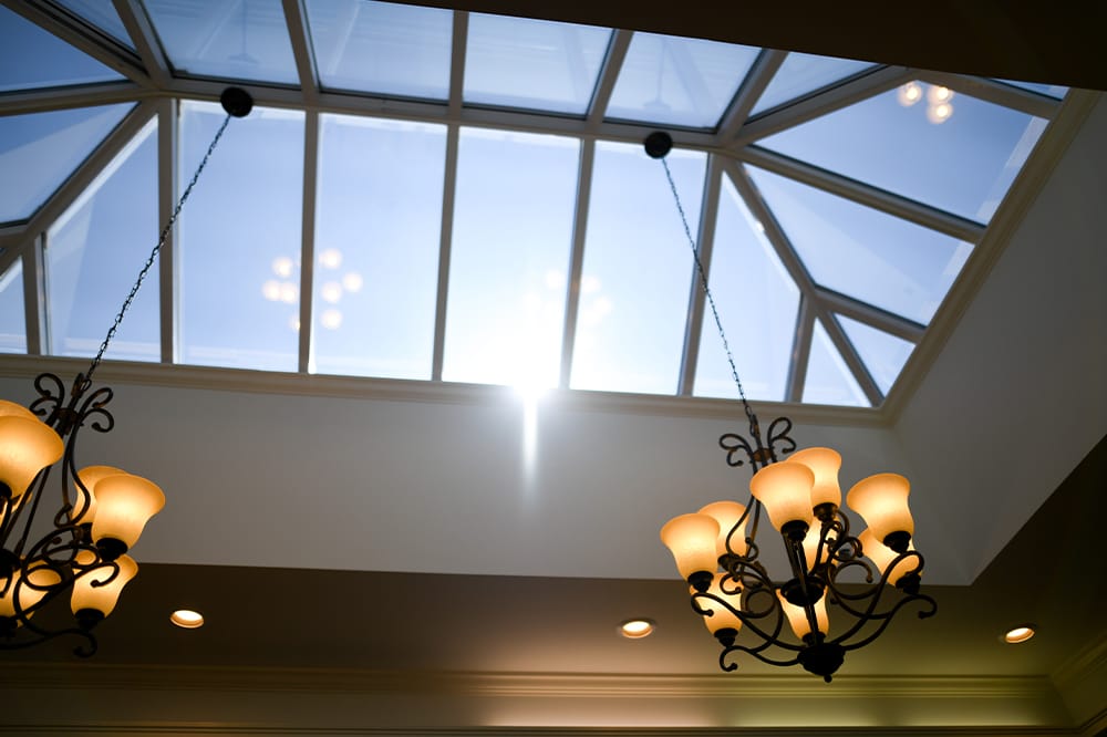 Chandelier under skylight in a facility interior