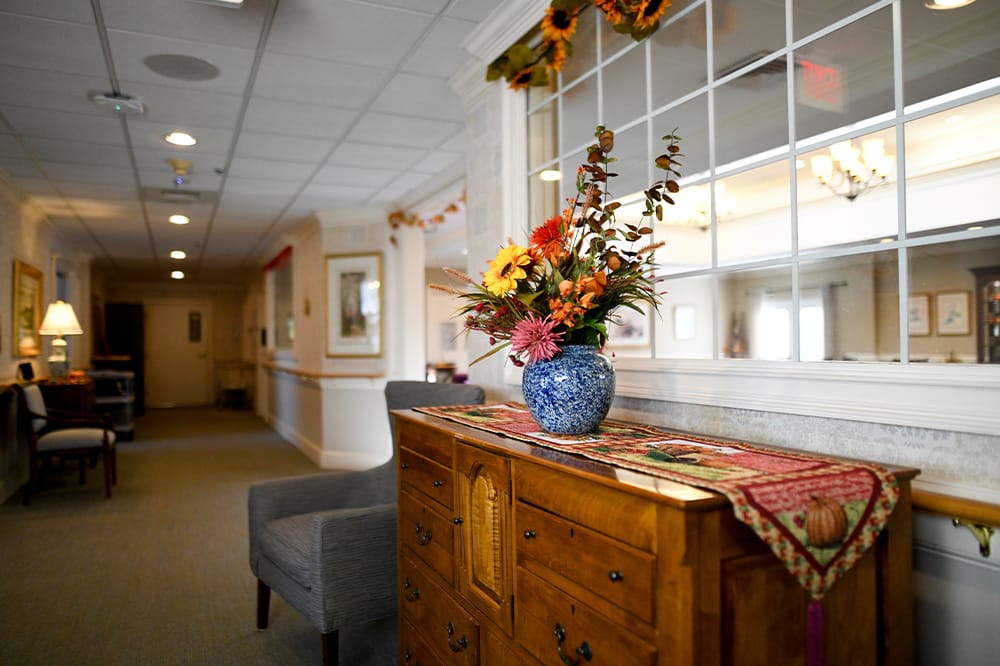 Interior hallway with floral arrangement on side table