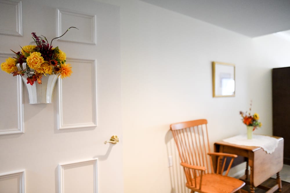 Cozy interior with floral decor and a wooden chair