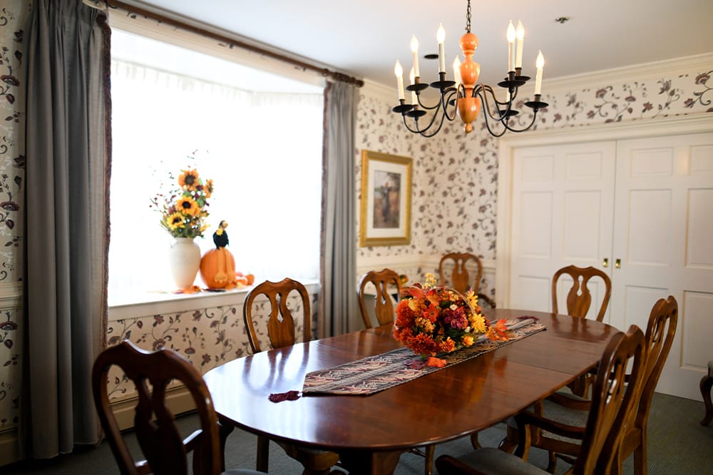 Dining room with autumn decorations and a large table