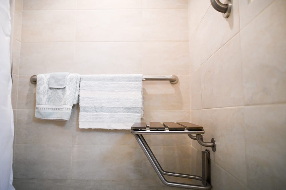 Clean shower area with towels displayed