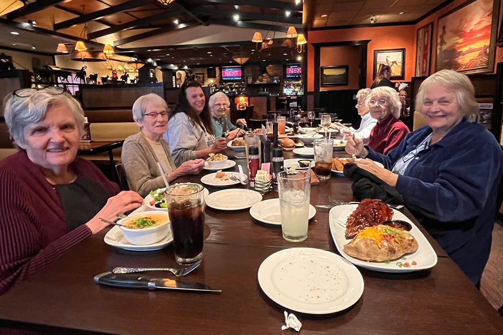 Residents enjoying a meal together in the dining room