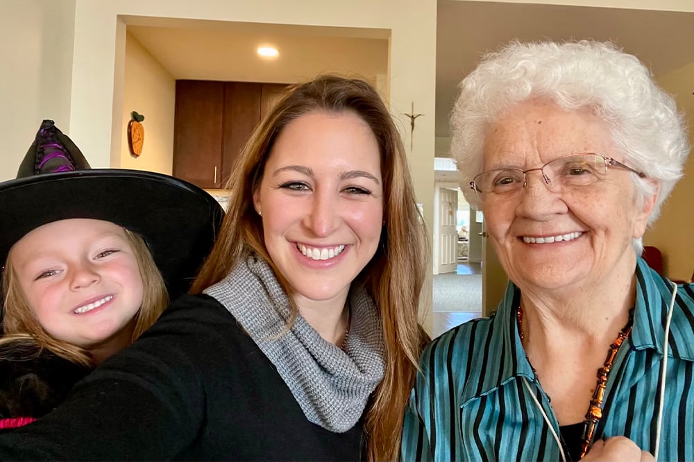 A resident and staff member smiling together