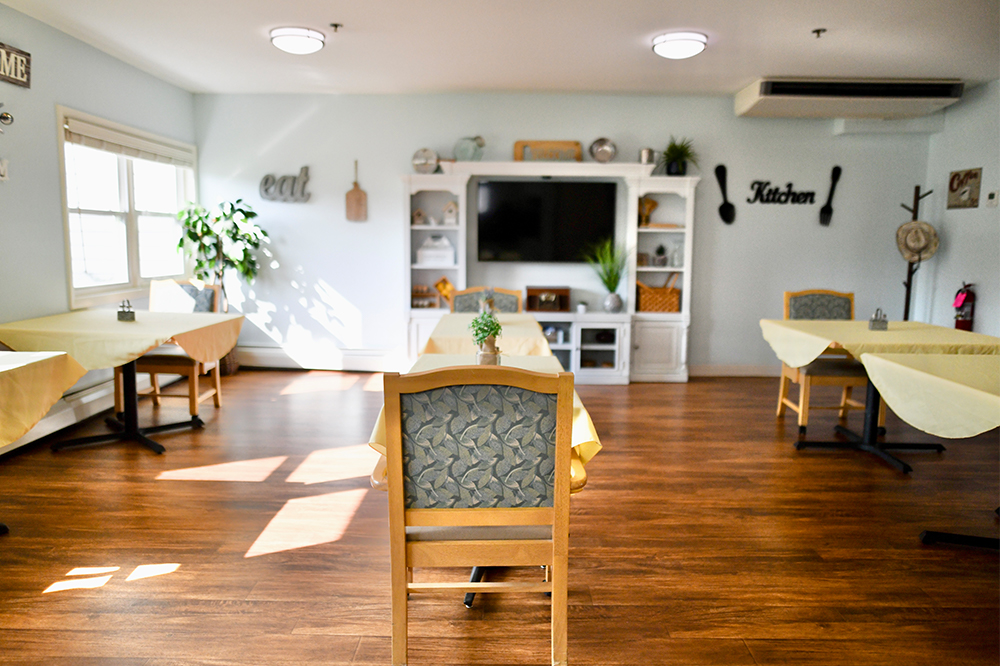 Dining area with tables and chairs in a bright room