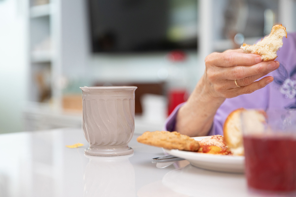Close-up of a resident enjoying food at a table