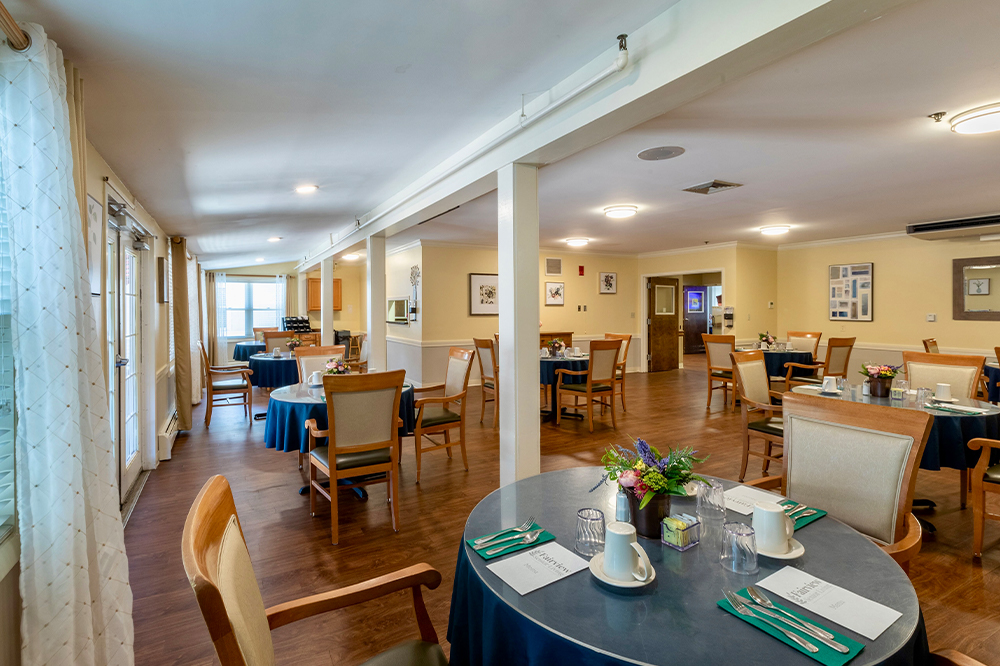 Bright dining room with tables set for meals