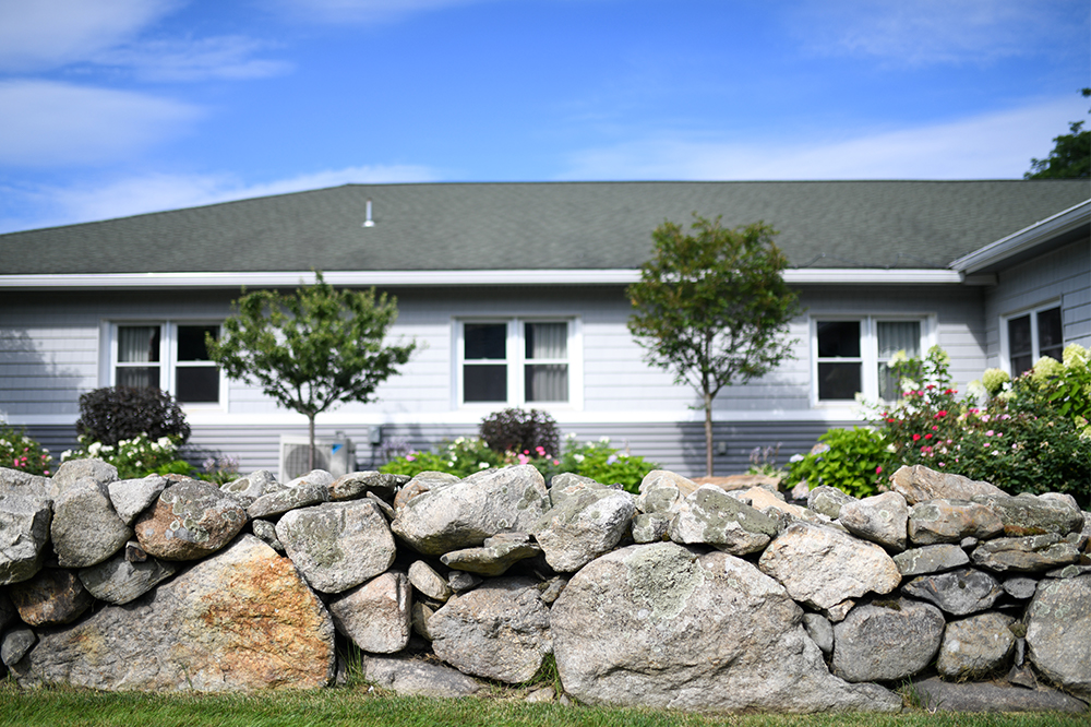 Exterior view of assisted living facility with garden