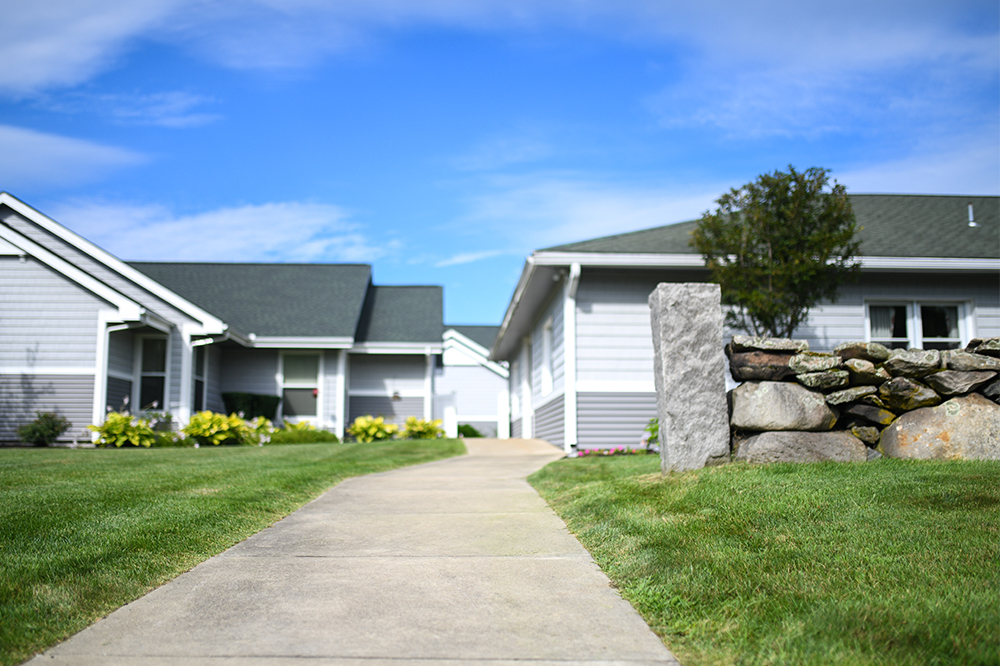 Pathway leading to residential buildings with landscaping
