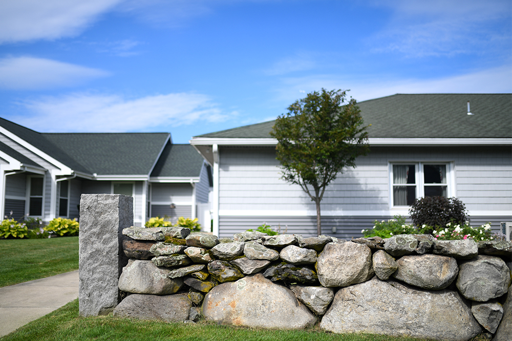 Outdoor view of a building with stone wall and garden