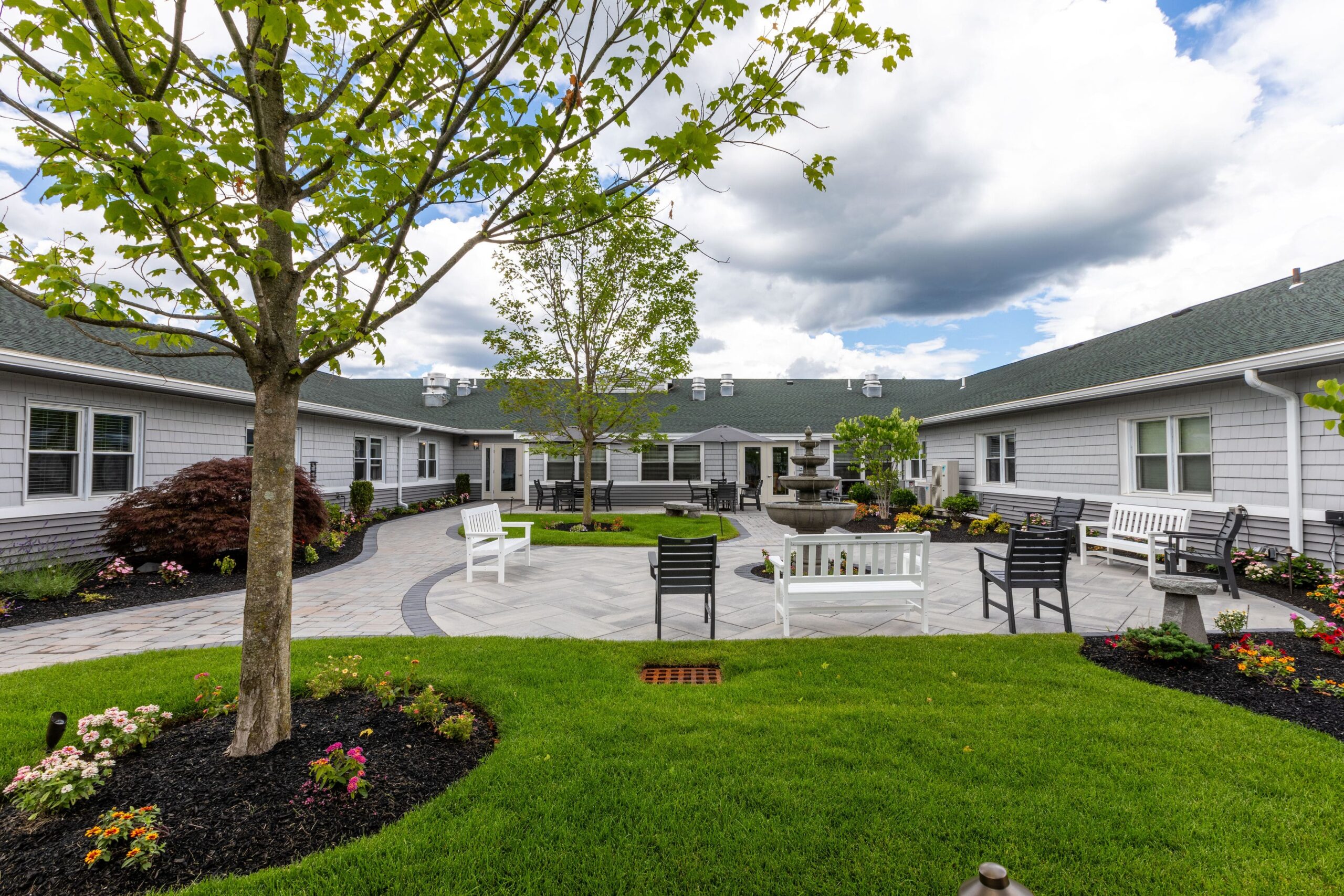 Outdoor courtyard with benches and gardens