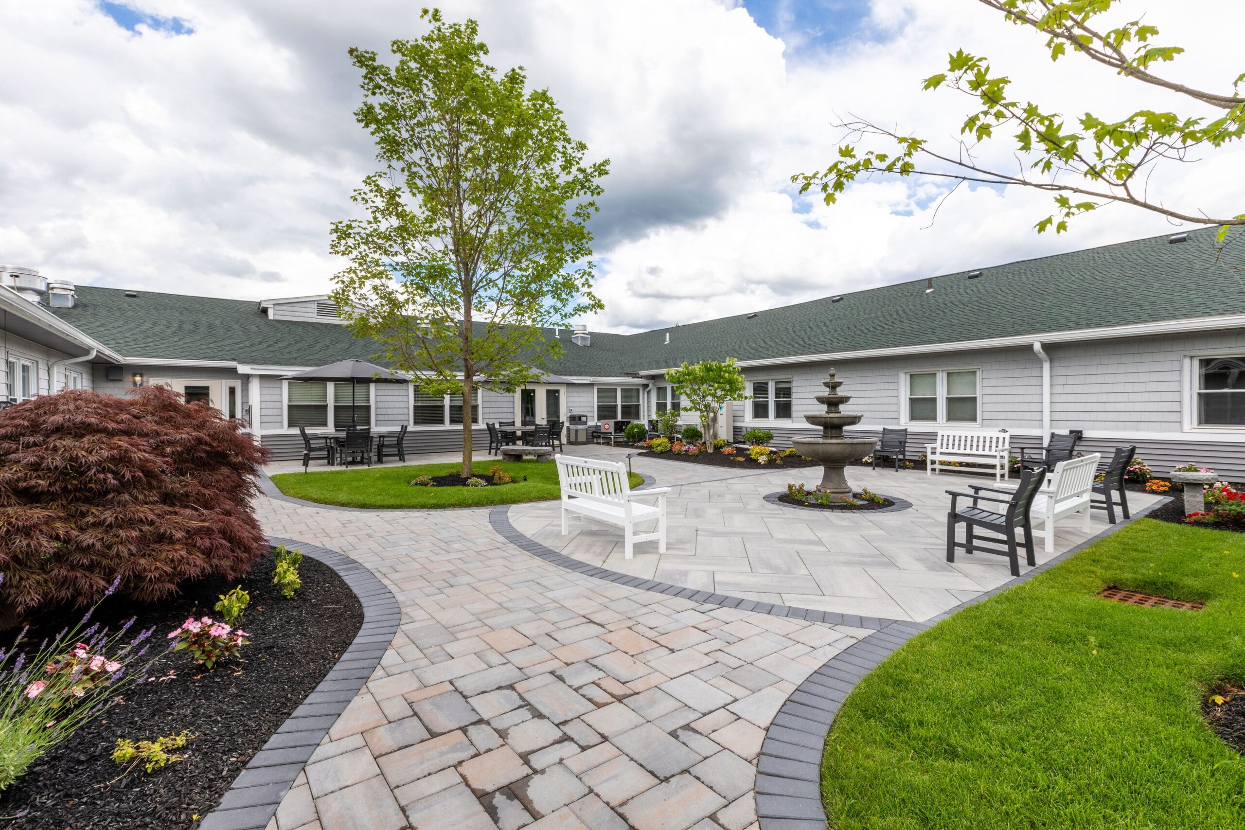 Gardens and seating area in a senior living courtyard