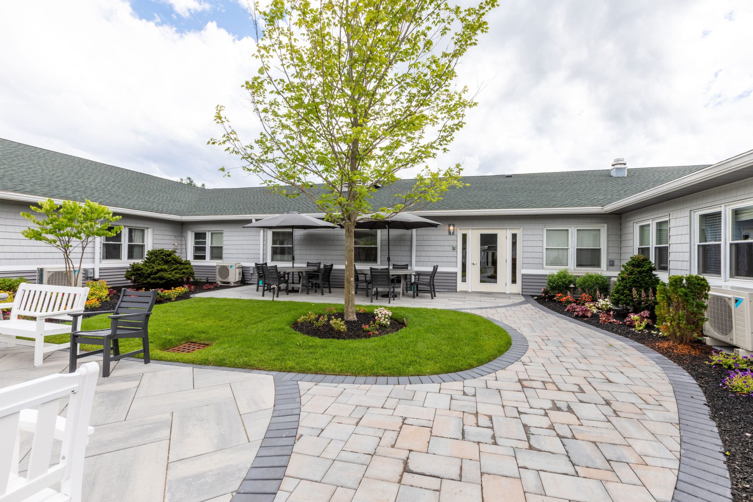 Outdoor patio area with seating and landscaped gardens