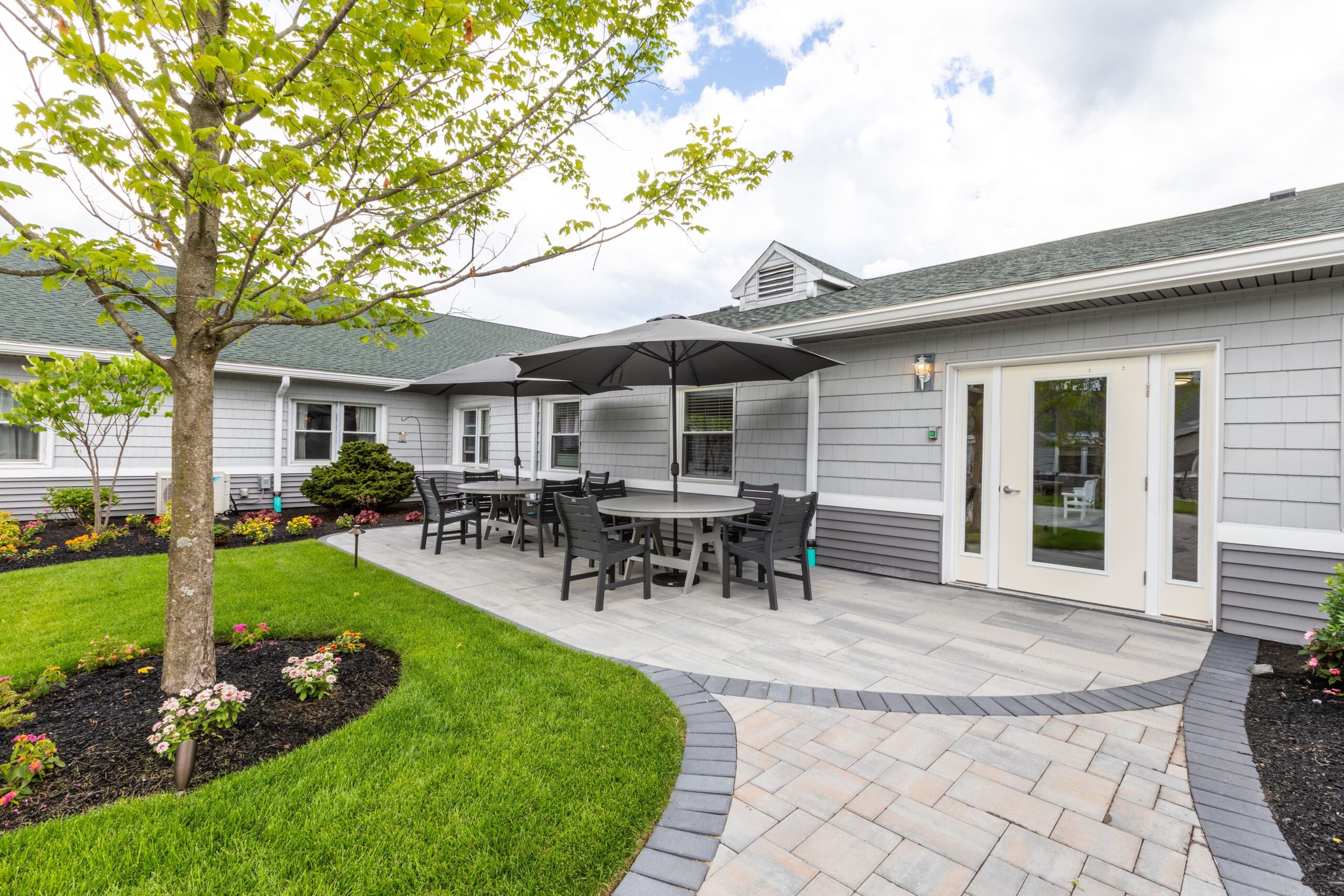 Outdoor patio area with seating and landscaping