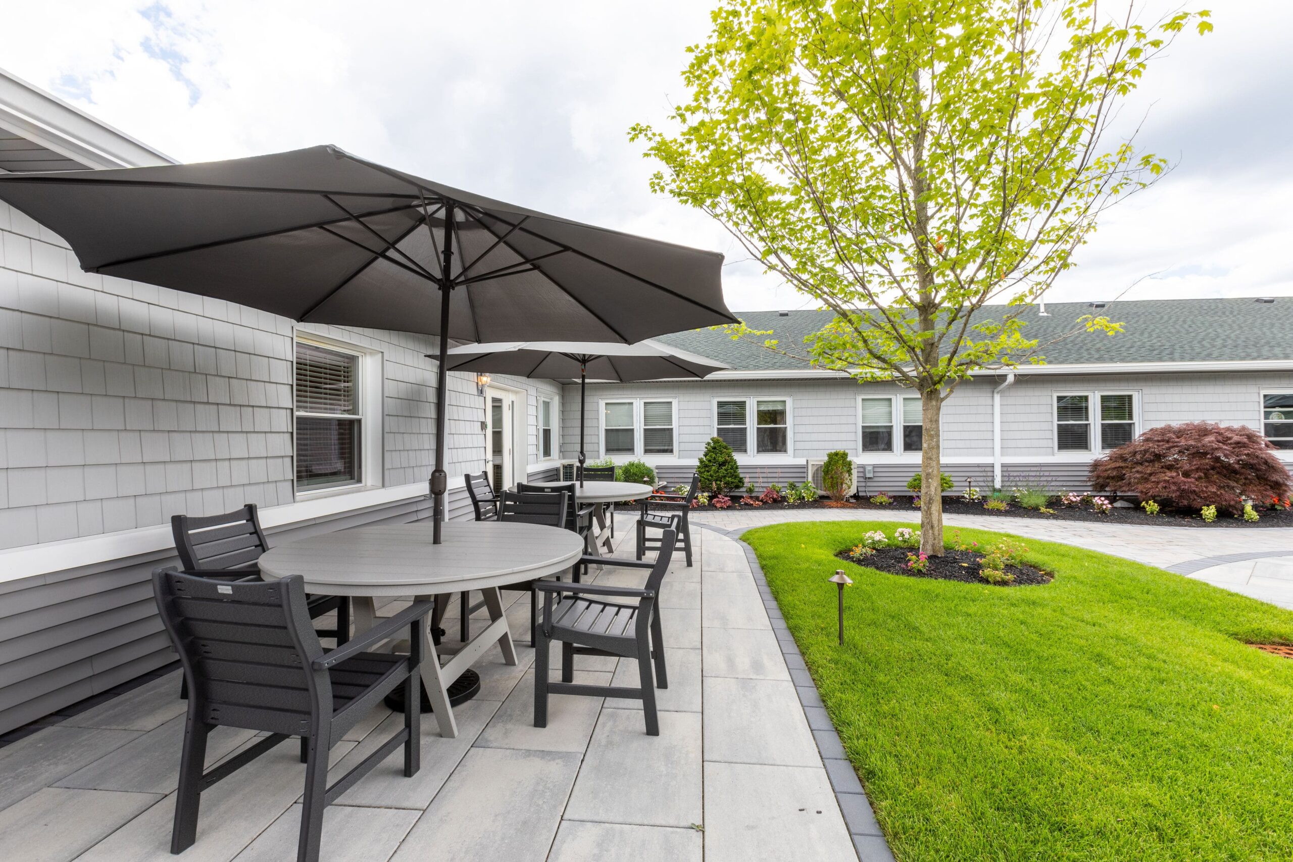 Outdoor seating area with umbrellas and landscaping