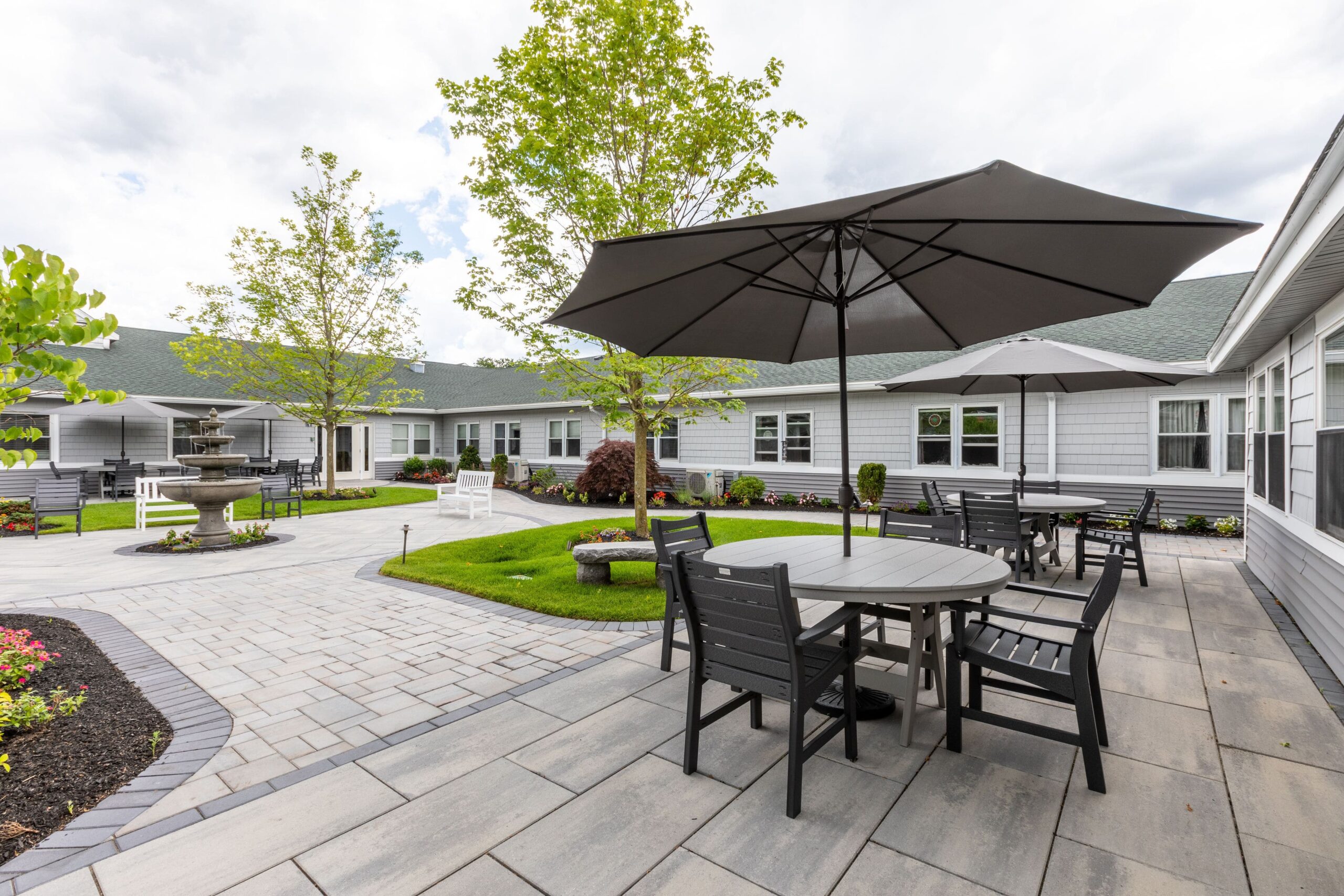 Beautiful outdoor seating area with umbrellas and landscaped gardens