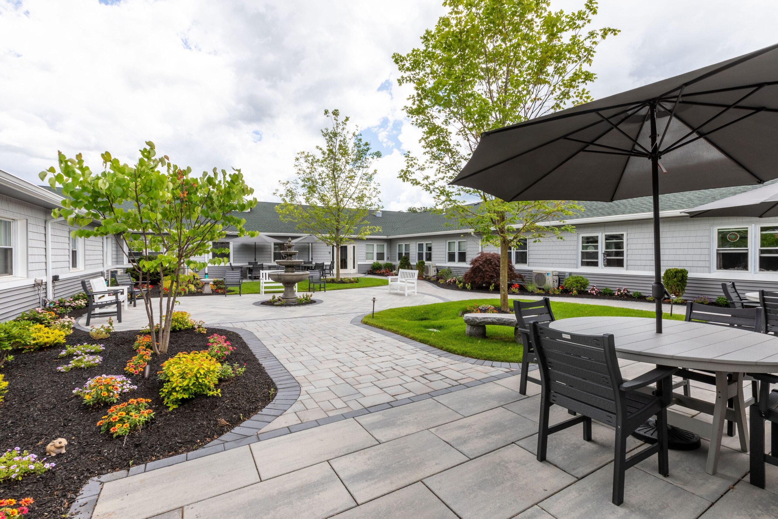 Outdoor patio area with gardens and seating