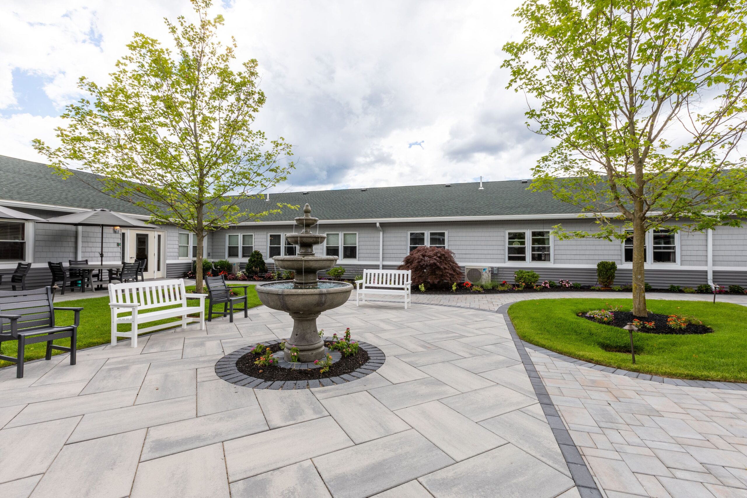 Serene outdoor garden with a fountain and seating