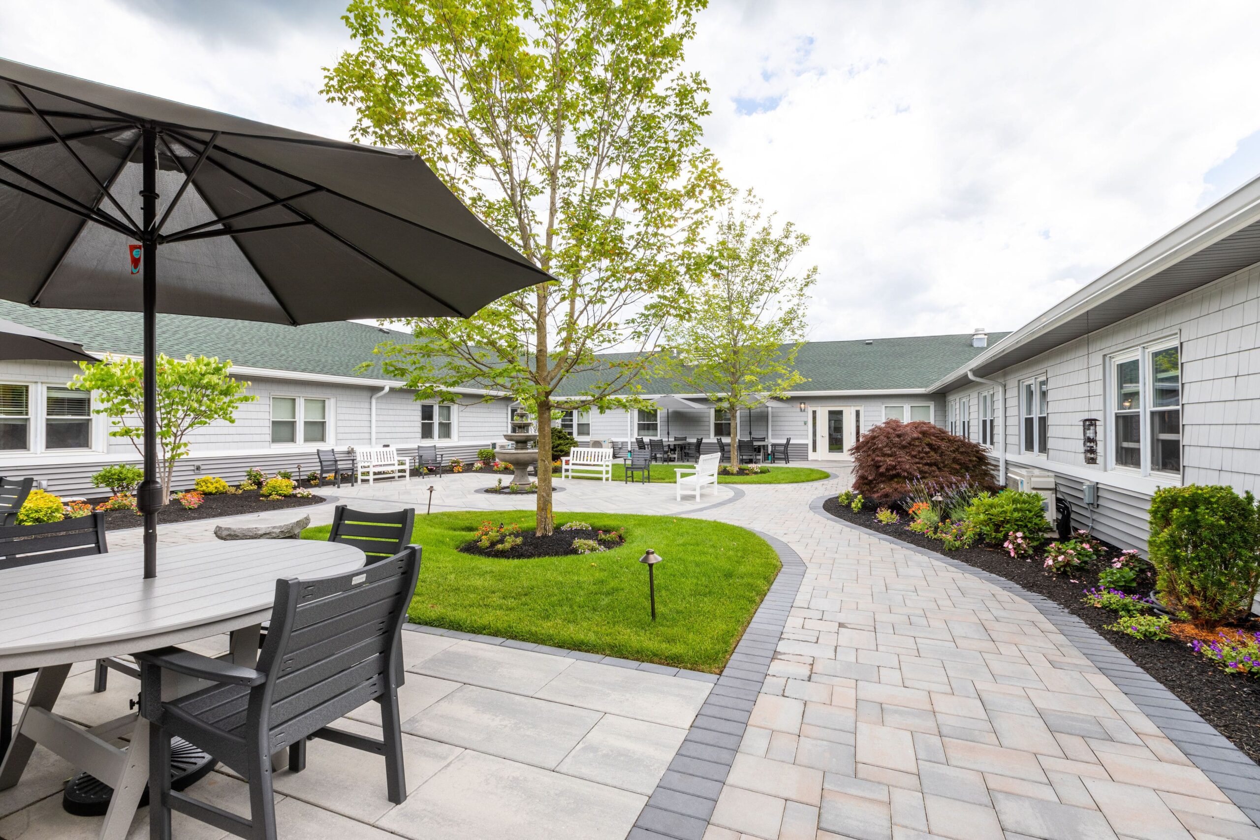 Well-maintained outdoor courtyard with seating and landscaping