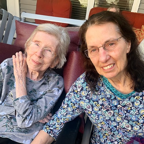 Two residents enjoying time outdoors on a sunny day